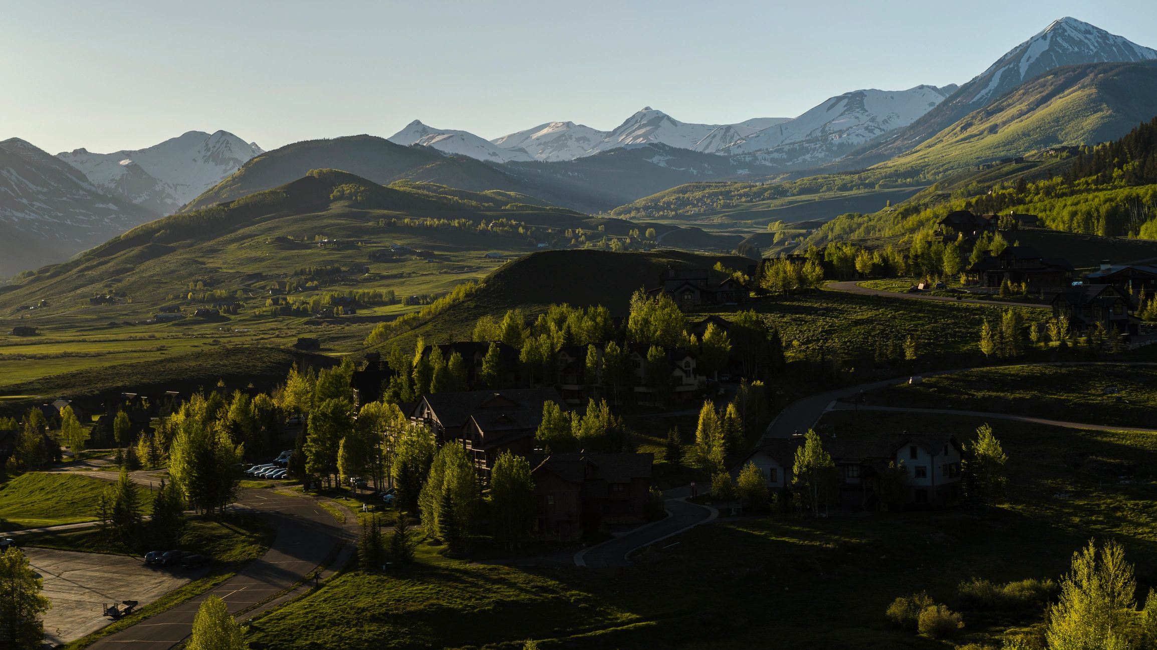 Misty mountain valley with dark wooded ridges