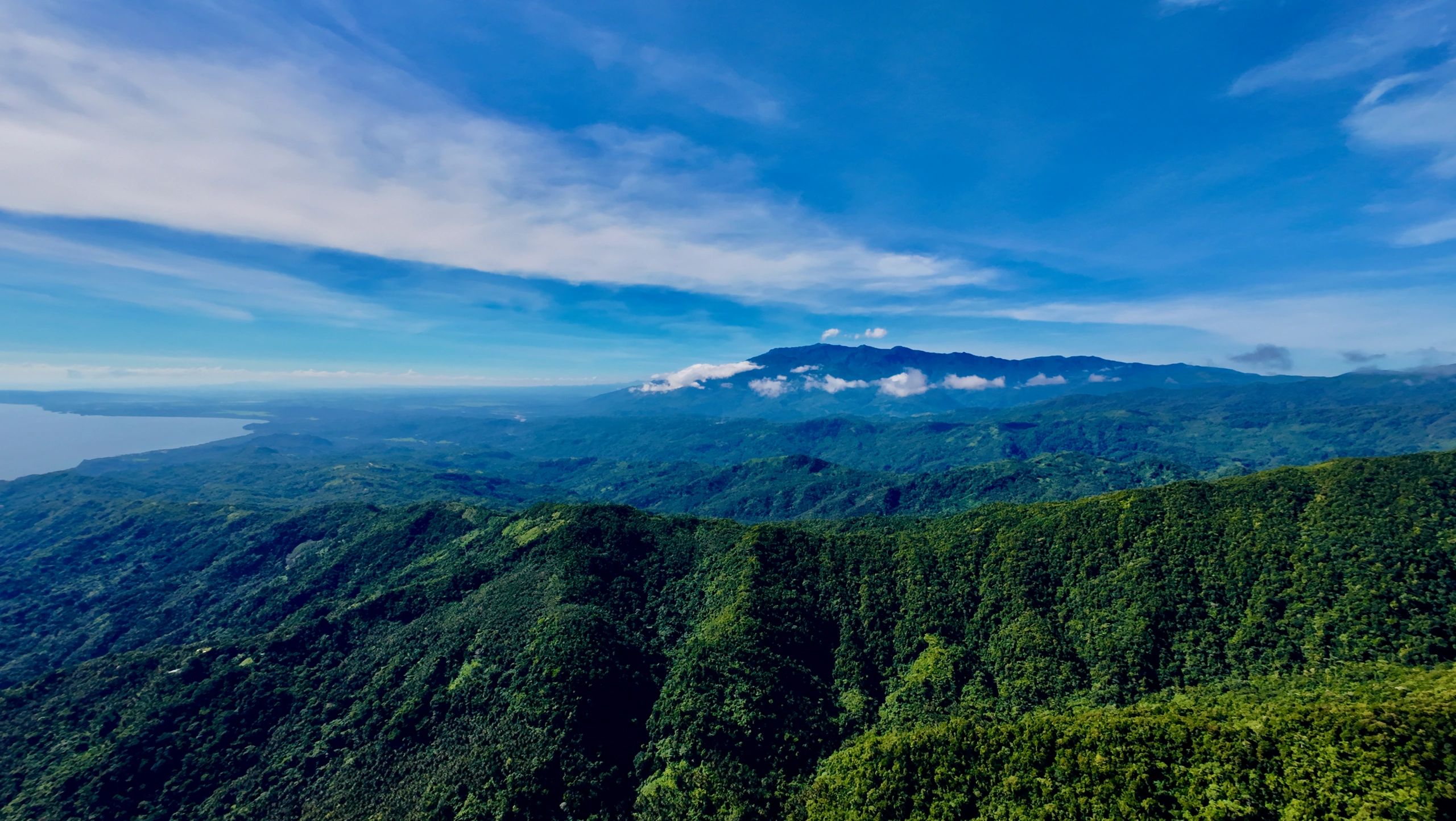 Mountain landscape with layered ridges and distant lake