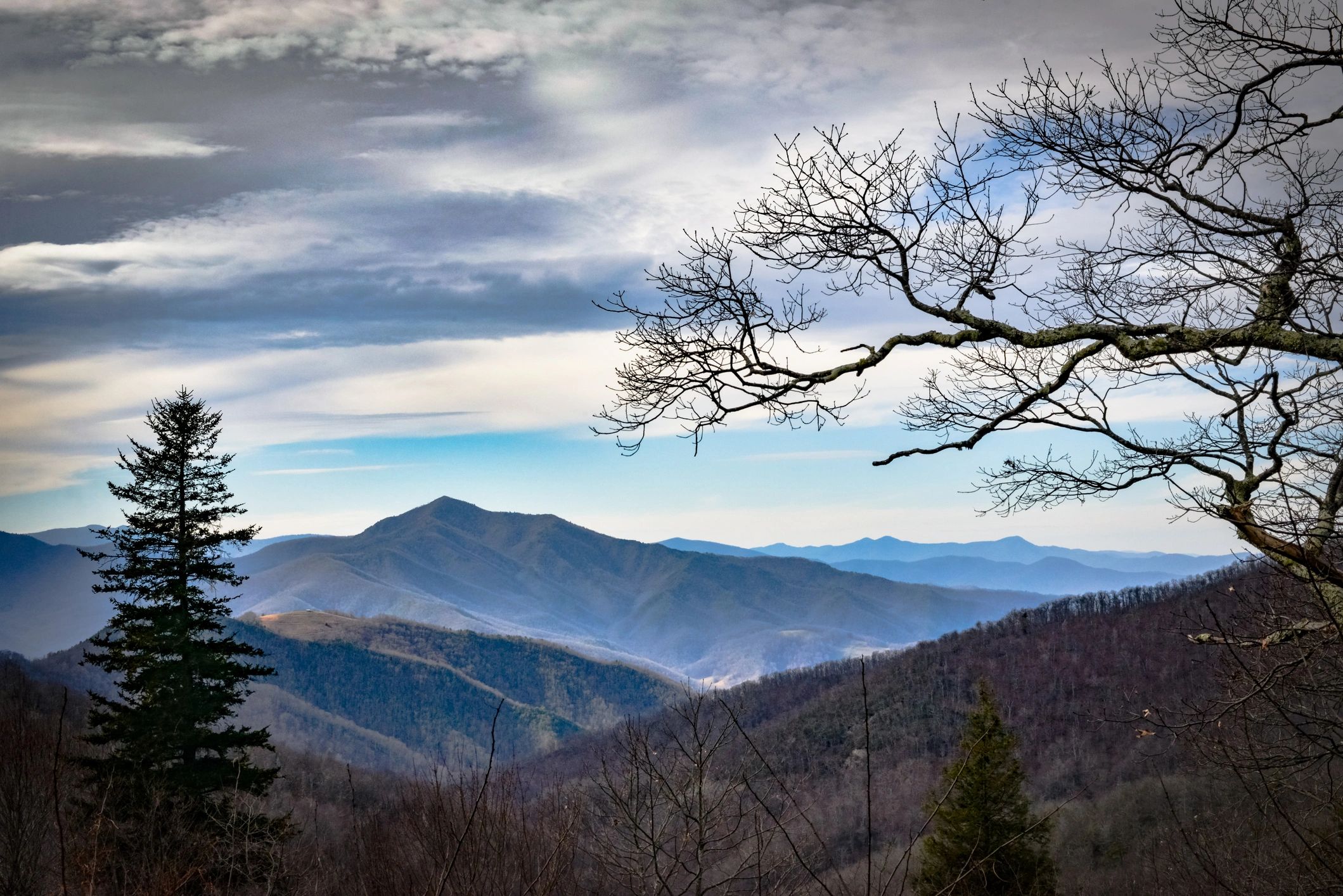 Fog rolling over dark Appalachian mountain ridges